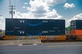 Double-stacked shipping containers with Amazon Prime logo on moving freight train in city Royalty Free Stock Photo