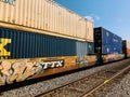 Freight train with cargo containers and graffiti