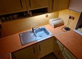 double stainless steel sink in the horseshoe-shaped kitchen. yellow painted