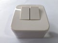 Double surface-mounted electrical switch (two-gang), in beige ivory color Royalty Free Stock Photo