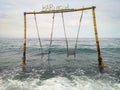 Double swing in the ocean at the beach in Amed village in Bali Indonesia