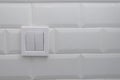 double switch on glossy porcelain wall Royalty Free Stock Photo