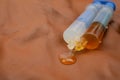 Double syringe with epoxy gel glue spilling on genuine brown leather texture, soft focus close up Royalty Free Stock Photo