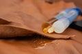 Double syringe with epoxy gel gluing and spilling on genuine brown leather texture, soft focus Royalty Free Stock Photo