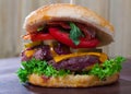 Double tasty hamburger with beef cutlet, fresh vegetables and cheese Royalty Free Stock Photo