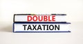 Double taxation symbol. Concept words Double taxation on books on a beautiful white table white background. Business tax and