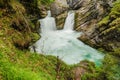 double waterfall with a basin and green plants and rocks named strumboding waterfall