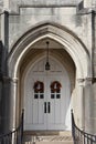 Double white catherdral doors surrouned by ancient entry way. Royalty Free Stock Photo