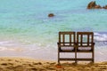 Double wooden chairs to sit at the sea on the beach Royalty Free Stock Photo