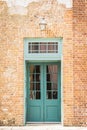 Double wooden doors on the front of a brick home Royalty Free Stock Photo