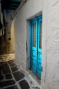 Blue double door in a dark alley in Greece. Royalty Free Stock Photo