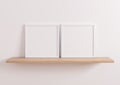 Double 10x10 Square White Frame mockup on wooden shelf and white wall