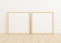 Double 10x10 Square Wood Frame mockup on wooden floor and white wall