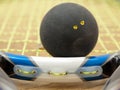 Double yellow dot squash ball on racket Royalty Free Stock Photo