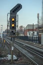 Double yellow railway signal on train track in UK