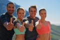 Double your chances for fitness success. a fitness group showing thumbs up.