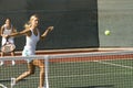 Doubles Player Hitting Tennis Ball With Backhand