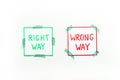 Doubt concept.. Right and wrong way icons on work desk from above Royalty Free Stock Photo