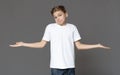 Unsure teenager boy shrugging with empty palms, hard choice Royalty Free Stock Photo