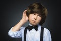 Doubt, expression and people concept - boy thinking over gray background