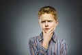 Doubt, expression and people concept - boy thinking over gray background