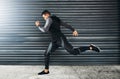 Doubt kills more dreams than failure ever will. a sporty young man running against a grey background. Royalty Free Stock Photo