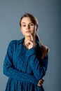 Doubt thinking female decision expression. Woman with finger on lips. A beautiful young woman is thinking and is doubtful. She has Royalty Free Stock Photo