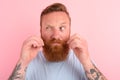 Doubter man with beard and light blue t-shirt Royalty Free Stock Photo