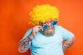 Fat doubter man with beard, tattoos and sunglasses has doubt about something Royalty Free Stock Photo