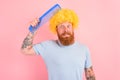 Doubter man with beard, yellow peruke and big comb Royalty Free Stock Photo