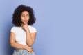 Doubtful african american young lady looking away on empty space. Royalty Free Stock Photo