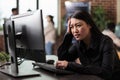 Doubtful asian computer engineer puzzled by nonfunctional security algorithm Royalty Free Stock Photo