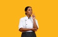 Doubtful Black Female Chef In Uniform Looking Up And Raising Finger Royalty Free Stock Photo