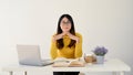 A doubtful Asian female college student pensively thinking about her school project Royalty Free Stock Photo