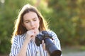 Doubtful photographer checking mirrorless camera