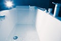 Douche filling a bathtub with water stream Royalty Free Stock Photo