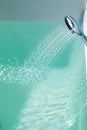 Douche filling a bathtub with water stream Royalty Free Stock Photo