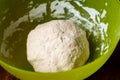 Dough ball in plastic bowl. Preparation of yeast dough for making bread, pizza bases Royalty Free Stock Photo