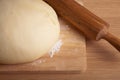 Dough on a board and rolling pin with flour dusting. Close-up Royalty Free Stock Photo