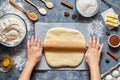 Dough bread, pizza or pie recipe traditional preparation. Female chef cook hands rolling dough with pin