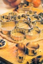 Dough cookie cutters Christmas gingerbread iced Kitchen table in Royalty Free Stock Photo