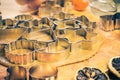 Dough cookie cutters Christmas gingerbread iced Kitchen table in Royalty Free Stock Photo