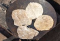 Dough flatbreads are fried in a frying pan Royalty Free Stock Photo