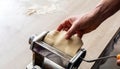 Fresh pasta maker machine. Dough homemade preparation. Hand make dough phylo close up view Royalty Free Stock Photo