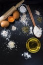 Dough ingredients on the black slates with olive oil Royalty Free Stock Photo