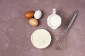 Dough ingredients, milk, eggs, flour and whisk, on the table, top view, background, no people, horizontal, Royalty Free Stock Photo