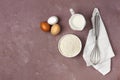 Dough ingredients, milk, eggs, flour and whisk, on the table, top view, background, no people, horizontal, Royalty Free Stock Photo