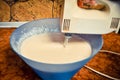 Dough for pancakes, whipped with a mixer in a blue salad bowl. concept of home food. Royalty Free Stock Photo