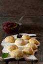 Dough for patties with cherry jam on a wooden table, on a board with flour Royalty Free Stock Photo