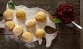 Dough for patties with cherry jam on a wooden table, on a board with flour Royalty Free Stock Photo